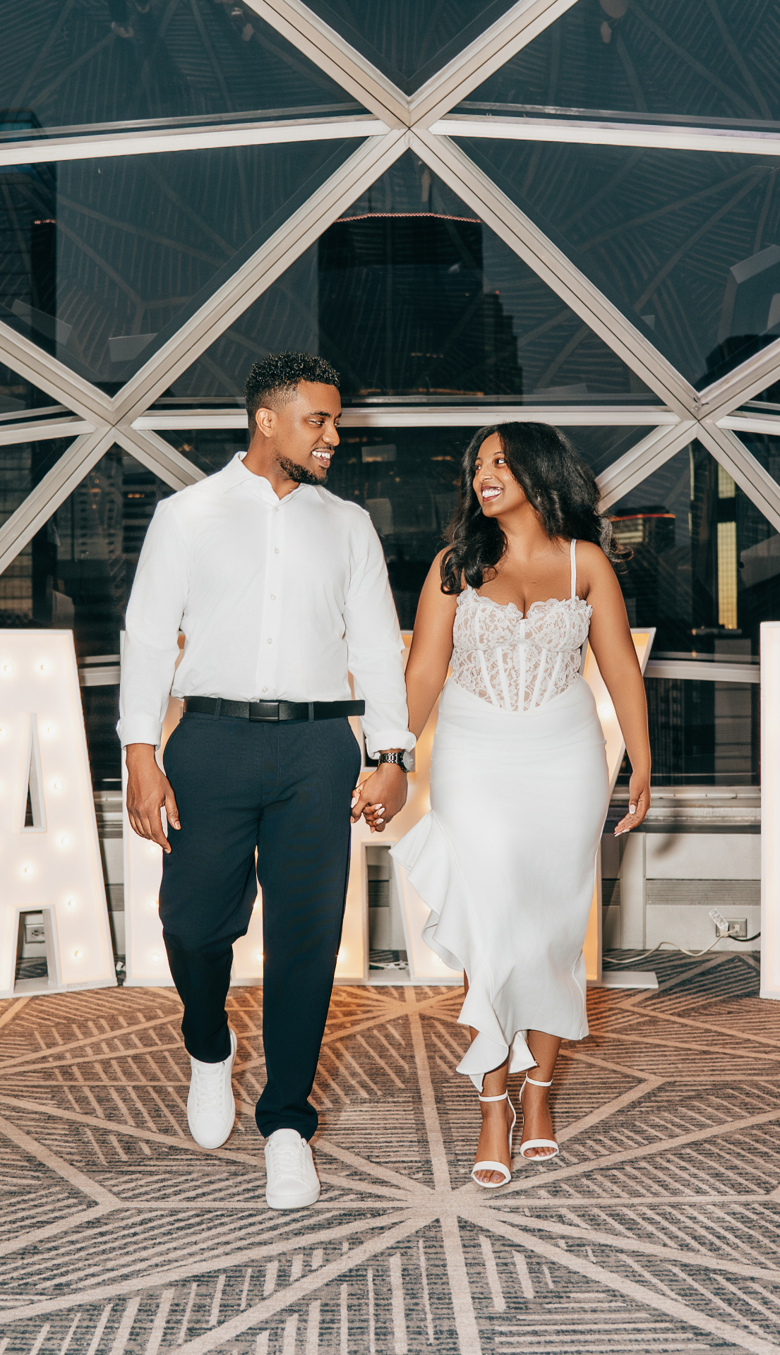 Samuel and Debora embracing in wedding attire
